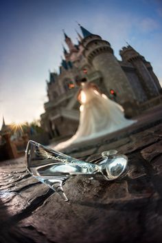 the bride and groom are standing in front of a castle with their wedding dress on