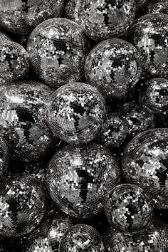 black and white photograph of disco balls with silver sequins in the middle,