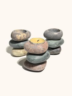 several rocks stacked on top of each other with a candle in the middle