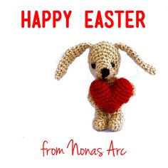 a crocheted bunny holding a heart with the words happy easter from thomas arc