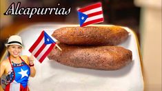 two sausages with american flags on them sitting on a white plate next to a woman