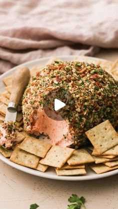 a platter with crackers and cheese ball on it