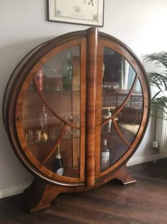 a wooden cabinet with glass doors and shelves