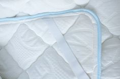 a close up view of a mattress with blue piping