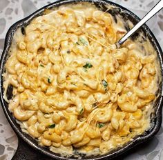 a bowl filled with macaroni and cheese on top of a table