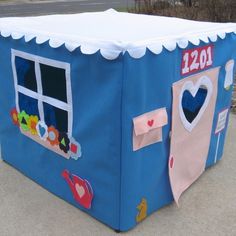 a child's play house with clothes hanging out the window and on the ground