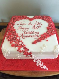 a heart shaped cake with red and white sprinkles