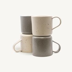 three coffee mugs stacked on top of each other