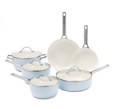 a set of blue pots and pans on a white background with one empty frying pan