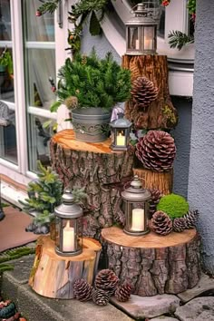 some pine cones are stacked on top of each other with lit candles in front of them