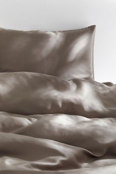 an image of a bed with sheets and pillows