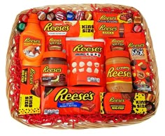 a basket filled with assorted candy and confection items, including reese's