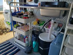 the inside of a camper with various items on it, including cups and containers