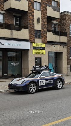 a car parked in front of a building on the street