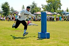 a man jumping in the air to catch a frisbee while people watch from behind him