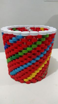 a red, yellow, and blue bracelet made out of legos on a table