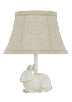 a white rabbit lamp with a beige shade