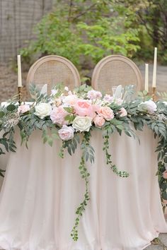 a table with flowers and candles on it