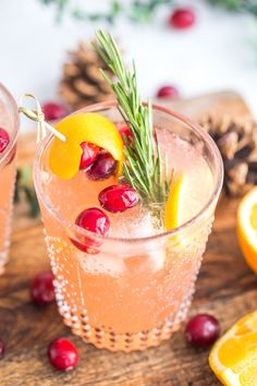 two glasses filled with cranberry lemonade and rosemary garnish