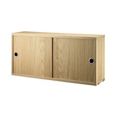 a wooden cabinet with two black holes in it