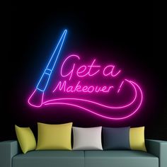 a neon sign that says geta makeover on the side of a wall next to a couch