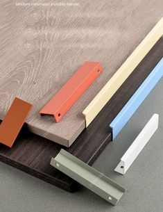 three different colors of wood are on the table