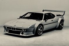 an old photo of a silver bmw sports car