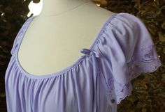 The sheer decadence of a good shade of lilac just hits different, ya know? It's playful, it's chic, it reminds you of a delicious macaroon. No? Just me. Oh well... this lovely Silk Essence by Miss Elaine dressing gown features: ✶Soft pastel billowy long tent dress silhouette with deep scoop neckline ✶Ethereal Lavendar nylon throughout ✶Loose, flowing pullover design with sweeping hemline. ✶Gathered front and back scoop neckline. ✶Dainty matching tie at wearer L upper side bust ✶Romantic gathered Sleeping Gown, Pastel Lilac, Hits Different, Tent Dress, Women's Nightgowns, Dressing Gown, Dress Silhouette, Pullover Designs, Scalloped Lace