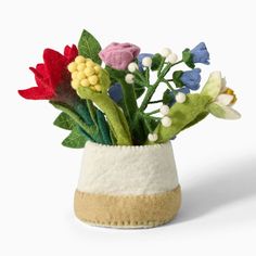 a vase filled with flowers on top of a white table