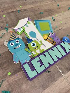 a birthday card with monsters on it and confetti around the edges that says lenn