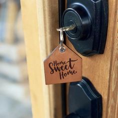 a door handle with a tag that says home sweet home hanging on it's side