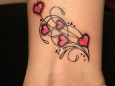 a woman's foot with hearts and swirls on the side, tattoo style