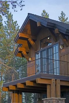 a large wooden house sitting in the middle of a forest