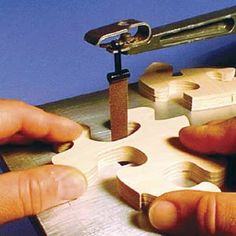 two hands are working on a puzzle piece