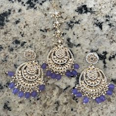 Earrings And Maangtika ( Forehead Chain With Hook) Lavender Color With Pearls And Kundan Work Brand New ( Never Worn ) Dimensions: Earrings Height 3.97 Inch X Width 2.5 Inch, Maang Tikka 6.5 Inch X Width 2.5 Inch Color May Look Different In Pictures But It’s Lavender Luxury Elegant Tikka With Zari Work, Forehead Chain, Lavender Jewelry, Ethnic Indian Wear, Jewelry Kundan, Kundan Work, Maang Tikka, Purple Earrings, Lavender Color