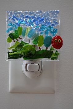 a light switch cover with an image of the very hungry caterpillars on it