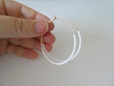 These hoops are gold filled and they have dainty and high quality white seed beads. Also available with sterling silver, 14kt gold and 14kt rose gold (choose preference at checkout).❤ SIZESThey measure 45 mm in diameter.❤ PROCESSING AND SHIPPINGMost orders are made and shipped out in one business day. Please check delivery timeframes for your location on the description below.  ❤ CUSTOM ORDERSContact me to discuss you needs!Go back to my shop: https://www.etsy.com/shop/StephanieMartinCoSee more Large Gold Hoop Earrings, Hoop Earrings Big, Earrings Gold Hoop, Red Beaded Necklaces, Earrings Big, Big Hoop Earrings, Earrings Beaded, Jewelry Essentials, Beaded Hoop Earrings