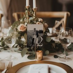 the table is set with candles, plates and wine glasses for an elegant wedding reception