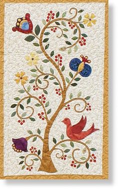 a tree with birds and berries on it is shown in this quilted wall hanging