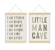 two wall hangings that have different types of words on them, one says i am strong and the other says little man cave