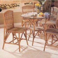 a dining room table with chairs and a vase on the wall in front of it