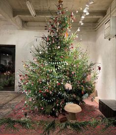 a large christmas tree sitting in the middle of a room