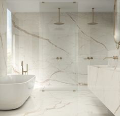 a white bath tub sitting next to a walk in shower