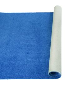 a blue yoga mat rolled up on top of it with a roll of white fabric next to it