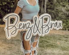 a woman holding a sign that says ben and blax in front of her