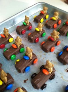 chocolate candies with teddy bears and candy on them in a baking pan, ready to be eaten