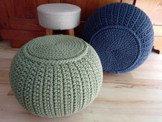 two knitted stools sitting next to each other on a wooden floor in front of a dresser