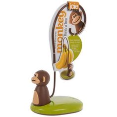 a toy monkey is plugged into a banana holder