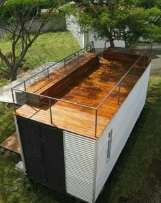 a small building with a roof made out of metal and wood