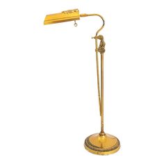 an antique brass desk lamp on a white background